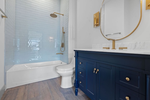 2450 Wickersham Ln Unit 2021, Austin, TX 78741 - full bathroom featuring toilet, wood finished floors, vanity, and shower / tub combination