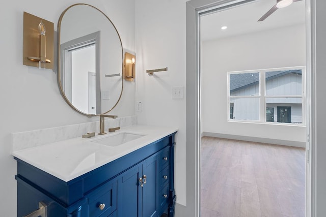 2450 Wickersham Ln Unit 2021, Austin, TX 78741 - bathroom with ceiling fan, wood finished floors, vanity, and recessed lighting