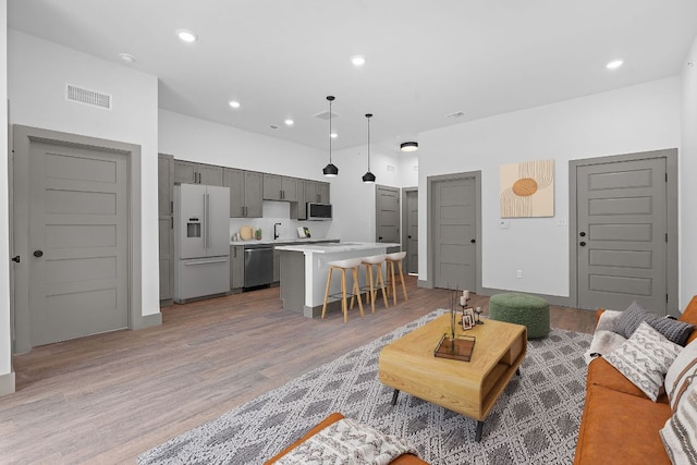 2450 Wickersham Ln Unit 2021, Austin, TX 78741 - living area featuring light wood-style flooring and recessed lighting
