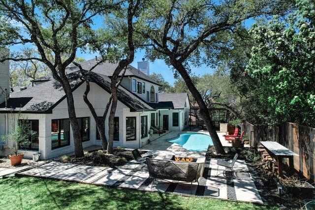 4500 Waterford Pl, Austin, TX 78731 - rear view of property with a patio area, a fenced backyard, an outdoor fire pit, a chimney, and roof with shingles