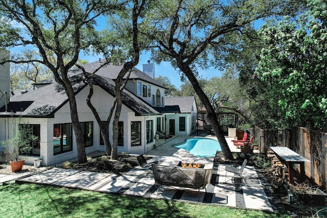 4500 Waterford Pl, Austin, TX 78731 - rear view of property featuring a patio area, a fenced backyard, a fire pit, a chimney, and a shingled roof