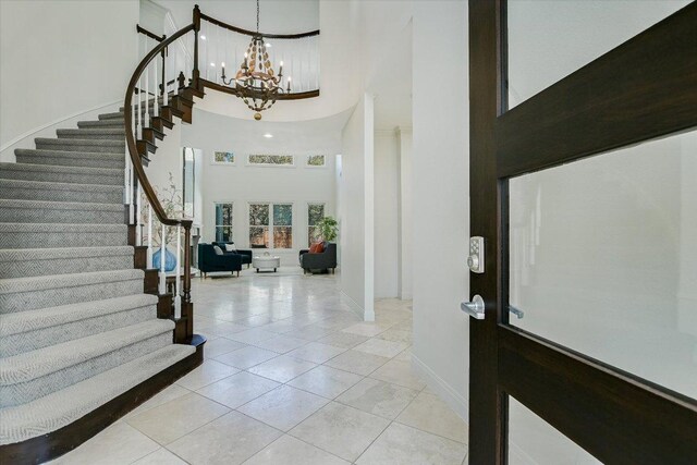 4500 Waterford Pl, Austin, TX 78731 - foyer entrance with a high ceiling, stairs, a chandelier, and light tile patterned floors