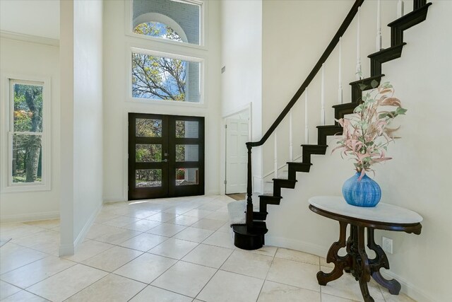 4500 Waterford Pl, Austin, TX 78731 - foyer with a towering ceiling, stairs, french doors, and light tile patterned flooring