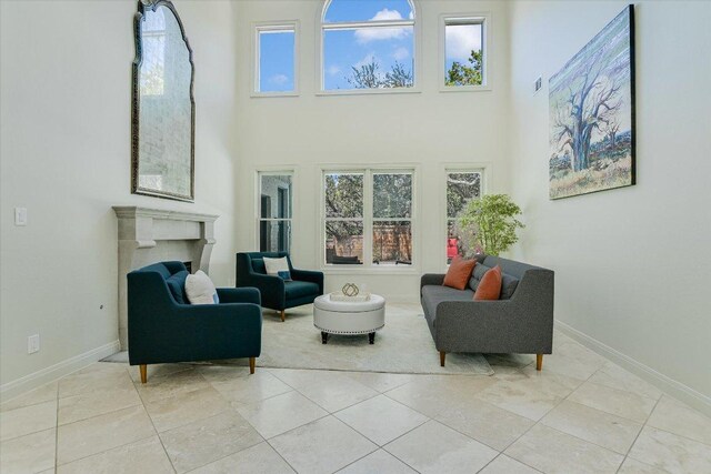 4500 Waterford Pl, Austin, TX 78731 - living room with a high ceiling, a fireplace, and light tile patterned flooring