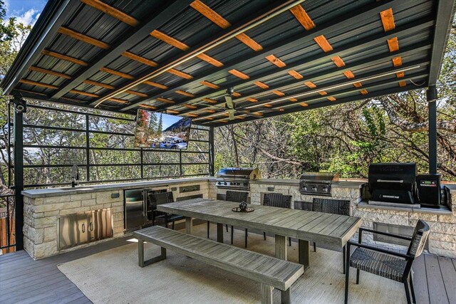 4500 Waterford Pl, Austin, TX 78731 - wooden terrace with exterior kitchen, a ceiling fan, and outdoor dining area
