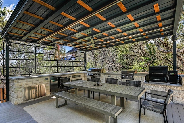 4500 Waterford Pl, Austin, TX 78731 - wooden terrace featuring an outdoor kitchen, ceiling fan, and outdoor dining area