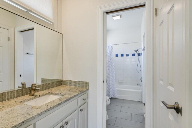 4500 Waterford Pl, Austin, TX 78731 - bathroom featuring tile patterned flooring, vanity, shower / bath combo with shower curtain, and tasteful backsplash