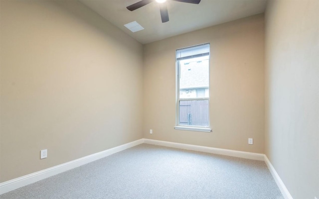 carpeted empty room with baseboards and ceiling fan