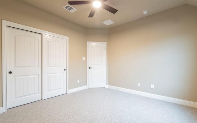 unfurnished bedroom with baseboards, carpet floors, visible vents, a ceiling fan, and a closet