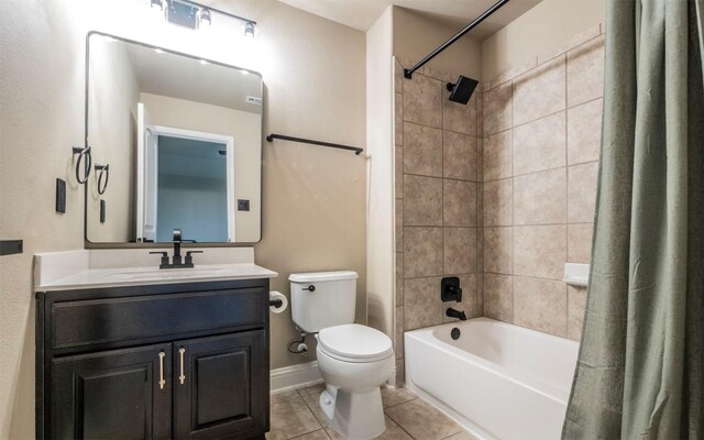 full bathroom featuring toilet, vanity, shower / bath combo, tile patterned flooring, and baseboards