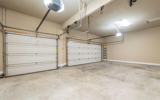 garage with baseboards and a garage door opener