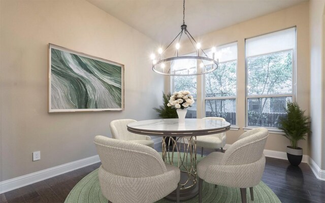 dining space with an inviting chandelier, baseboards, and wood finished floors