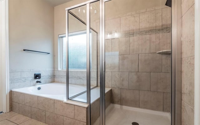 bathroom with a garden tub and a stall shower