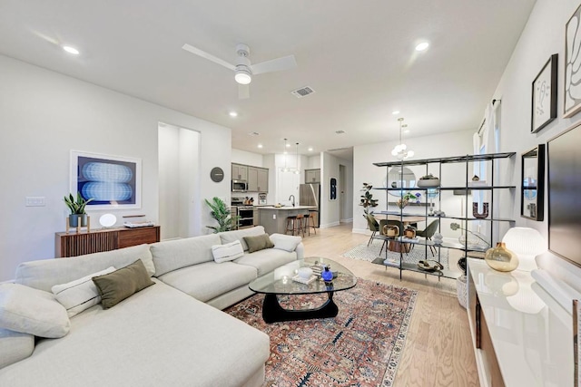 11808 Dillon Falls Dr, Austin, TX 78747 - living room with light wood-style flooring, ceiling fan, and recessed lighting