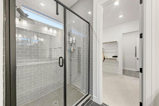 11808 Dillon Falls Dr, Austin, TX 78747 - full bath featuring a shower stall, a walk in closet, tile patterned flooring, and recessed lighting