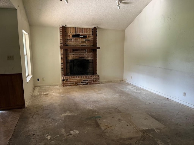 313 Golden Oaks Dr, Georgetown, TX 78628 - unfurnished living room with a textured ceiling and a brick fireplace