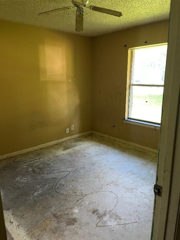 313 Golden Oaks Dr, Georgetown, TX 78628 - empty room with a ceiling fan and a textured ceiling