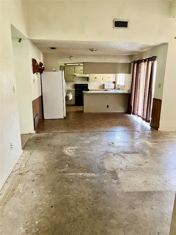 313 Golden Oaks Dr, Georgetown, TX 78628 - unfurnished living room featuring unfinished concrete floors