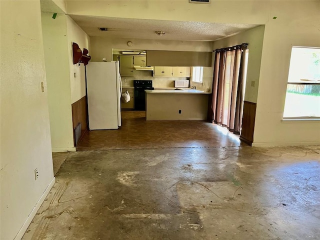 313 Golden Oaks Dr, Georgetown, TX 78628 - unfurnished living room with unfinished concrete floors, baseboards, and a textured ceiling