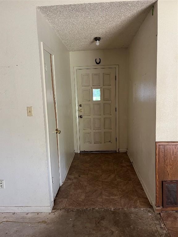 313 Golden Oaks Dr, Georgetown, TX 78628 - foyer with baseboards and a textured ceiling
