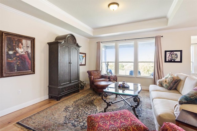 231 Tradinghouse Creek St, Georgetown, TX 78633 - living room with a raised ceiling, ornamental molding, baseboards, and wood finished floors