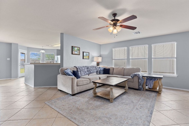 301 Drystone Trl, Liberty Hill, TX 78642 - living area with light tile patterned floors, ceiling fan, and baseboards
