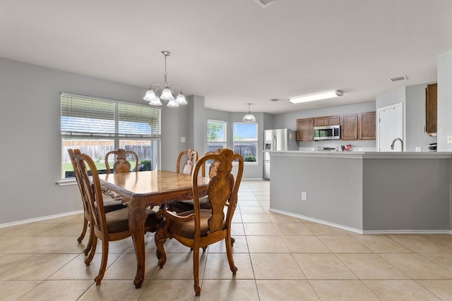 301 Drystone Trl, Liberty Hill, TX 78642 - dining area featuring light tile patterned floors, a chandelier, and baseboards