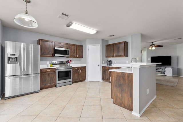 301 Drystone Trl, Liberty Hill, TX 78642 - kitchen with appliances with stainless steel finishes, light tile patterned floors, a peninsula, open floor plan, and light countertops