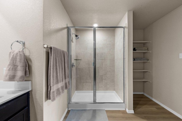 8517 Cantera Ridge Rd, Temple, TX 76502 - full bathroom with wood finished floors, a stall shower, vanity, and a textured ceiling
