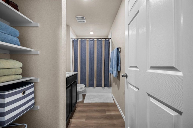 8517 Cantera Ridge Rd, Temple, TX 76502 - bathroom with a shower with shower curtain, wood finished floors, vanity, toilet, and a textured wall
