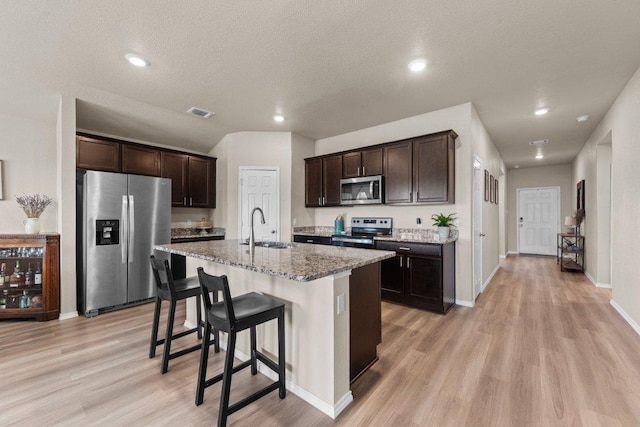 8517 Cantera Ridge Rd, Temple, TX 76502 - kitchen with appliances with stainless steel finishes, a sink, light wood-style floors, dark brown cabinets, and recessed lighting