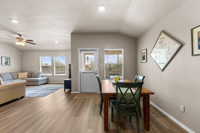 8517 Cantera Ridge Rd, Temple, TX 76502 - dining space featuring wood finished floors, a ceiling fan, vaulted ceiling, baseboards, and a textured ceiling