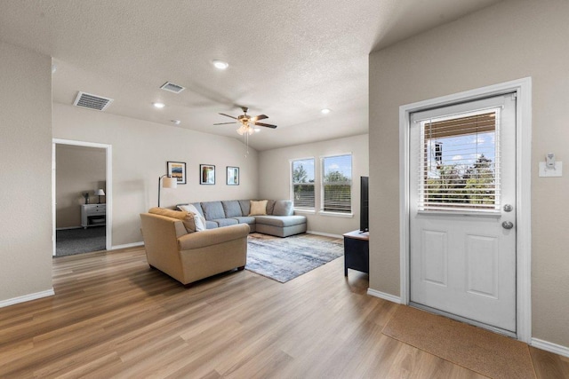 8517 Cantera Ridge Rd, Temple, TX 76502 - living room featuring light wood-style flooring, a textured ceiling, ceiling fan, baseboards, and recessed lighting