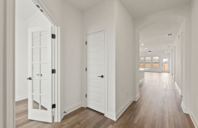 417 Singing Dove Way, Liberty Hill, TX 78642 - hall featuring wood finished floors and arched walkways