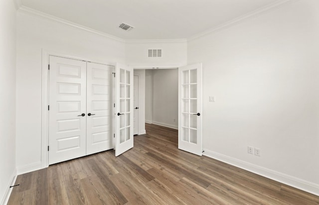 417 Singing Dove Way, Liberty Hill, TX 78642 - unfurnished bedroom featuring french doors, wood finished floors, ornamental molding, and a closet