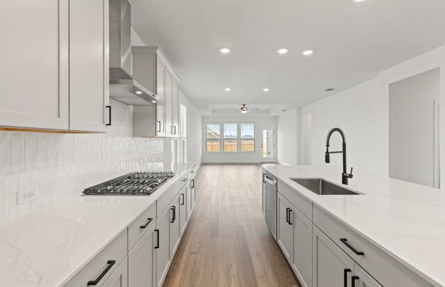 417 Singing Dove Way, Liberty Hill, TX 78642 - kitchen with wall chimney range hood, light wood-type flooring, recessed lighting, appliances with stainless steel finishes, and backsplash