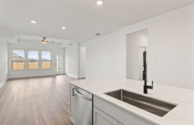 417 Singing Dove Way, Liberty Hill, TX 78642 - kitchen featuring stainless steel dishwasher, a sink, light wood-type flooring, a ceiling fan, and recessed lighting