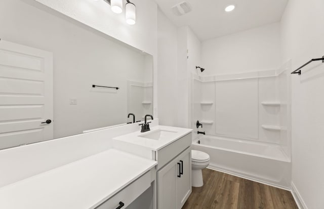 417 Singing Dove Way, Liberty Hill, TX 78642 - bathroom with vanity, wood finished floors, toilet, shower / washtub combination, and recessed lighting
