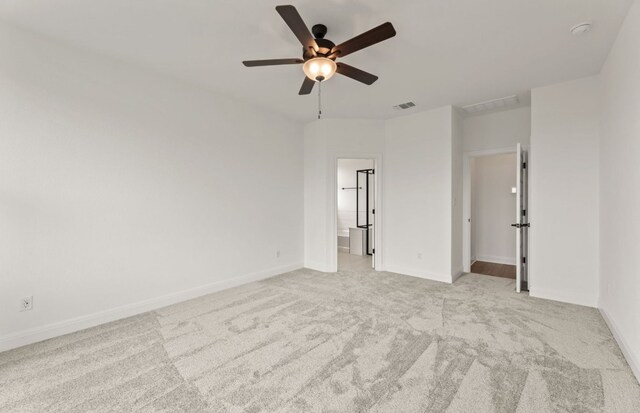 417 Singing Dove Way, Liberty Hill, TX 78642 - unfurnished bedroom featuring light carpet, ensuite bath, and ceiling fan