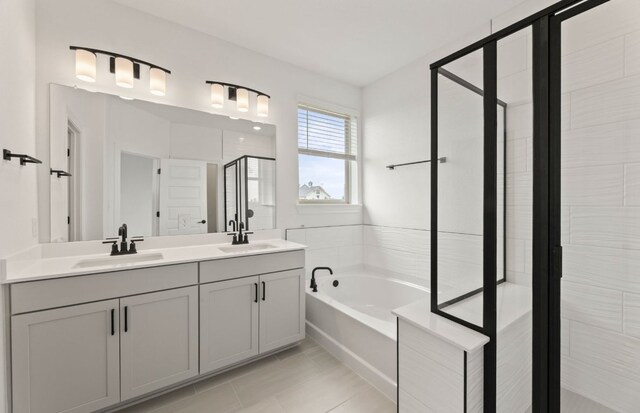 417 Singing Dove Way, Liberty Hill, TX 78642 - full bath featuring a stall shower, double vanity, a bath, and tile patterned flooring