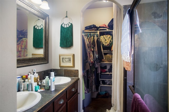 15405 Sutton Dr, Austin, TX 78734 - full bath with double vanity, a spacious closet, a shower stall, and tile patterned floors