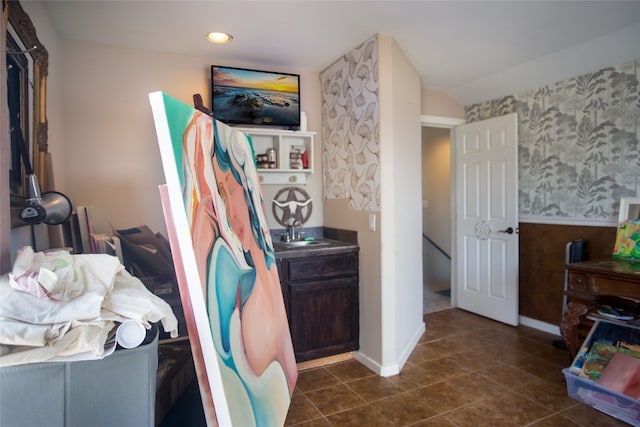 15405 Sutton Dr, Austin, TX 78734 - bedroom featuring wallpapered walls, wainscoting, and dark tile patterned flooring