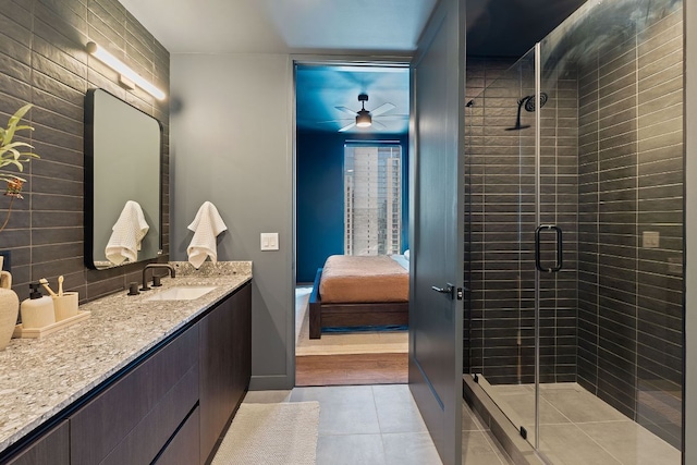 84 E Ave Unit 1904, Austin, TX 78701 - ensuite bathroom featuring vanity, a ceiling fan, a shower stall, and tile patterned flooring