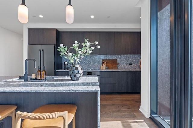 84 E Ave Unit 1904, Austin, TX 78701 - kitchen featuring high end refrigerator, modern cabinets, dark wood-style floors, tasteful backsplash, and recessed lighting