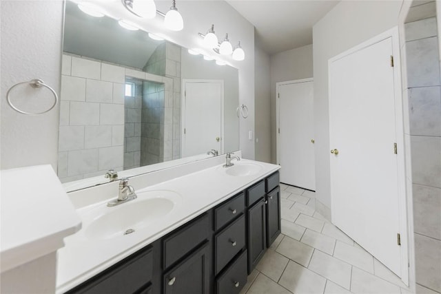 115 Hummingbird Ct, Cedar Creek, TX 78612 - full bath featuring double vanity, a tile shower, and tile patterned floors