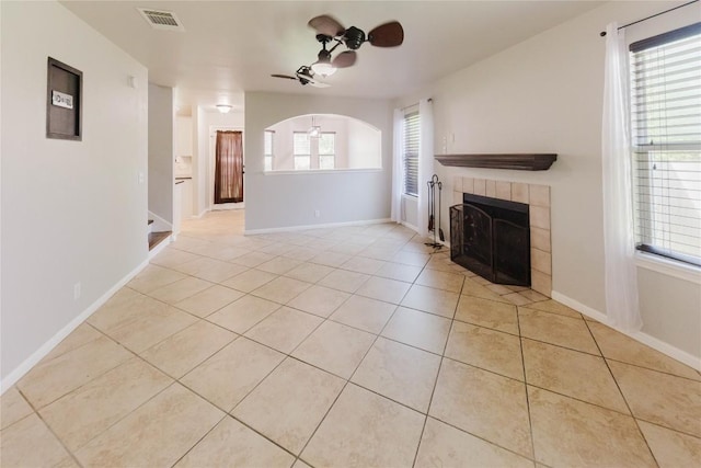 115 Hummingbird Ct, Cedar Creek, TX 78612 - unfurnished living room with a ceiling fan, light tile patterned flooring, a fireplace, and baseboards