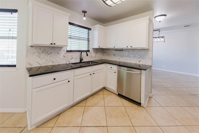 115 Hummingbird Ct, Cedar Creek, TX 78612 - kitchen with dishwasher, a sink, dark countertops, and tasteful backsplash