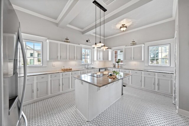517 N 9th St, Temple, TX 76501 - kitchen with stainless steel appliances, light stone counters, pendant lighting, a center island, and crown molding