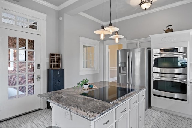 517 N 9th St, Temple, TX 76501 - kitchen featuring double oven, black electric cooktop, ornamental molding, dark stone countertops, and decorative light fixtures