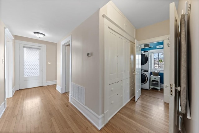 517 N 9th St, Temple, TX 76501 - hallway with stacked washer / dryer and light wood-style flooring